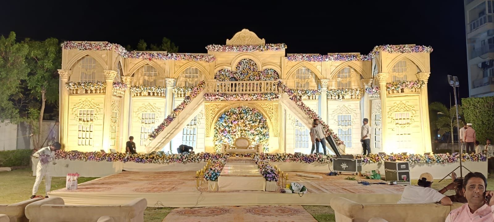 Royal wedding stage with layered floral styling