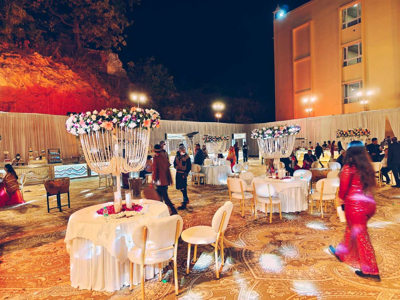 Night reception with chandeliers and decorated tables